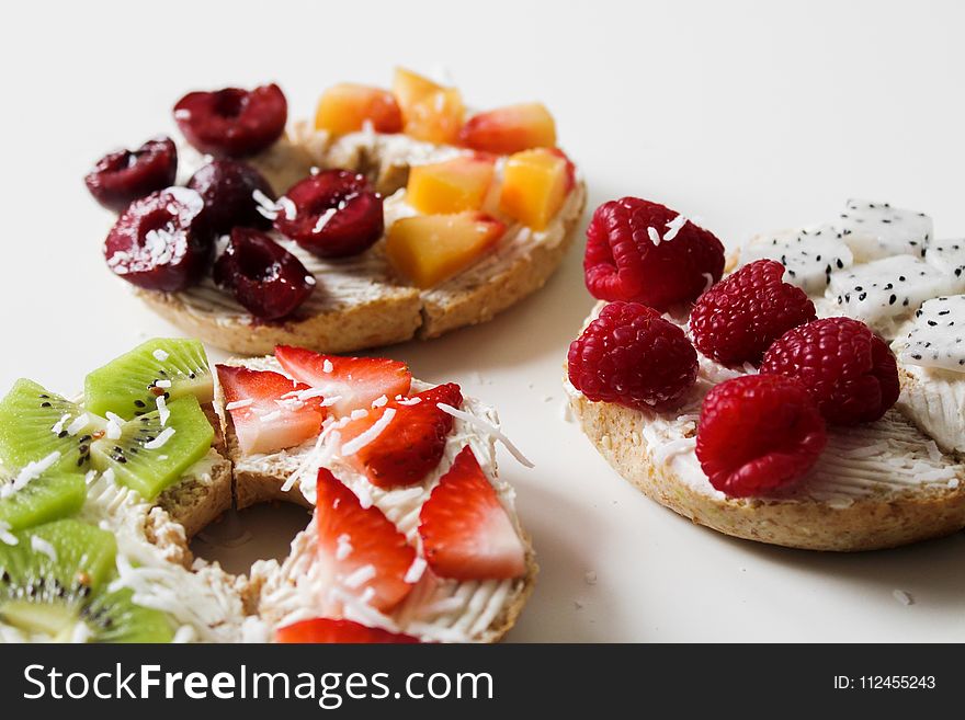 Sliced Variety of Fruits on Round Baked Bread