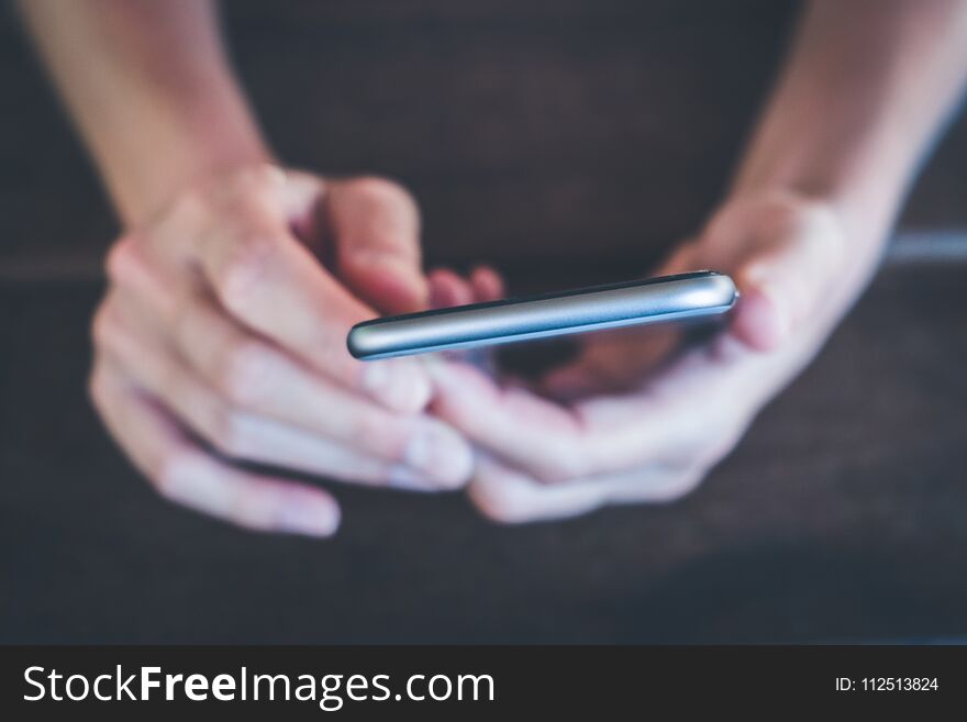 Hands holding phone macro - girl uses smartphone closeup -