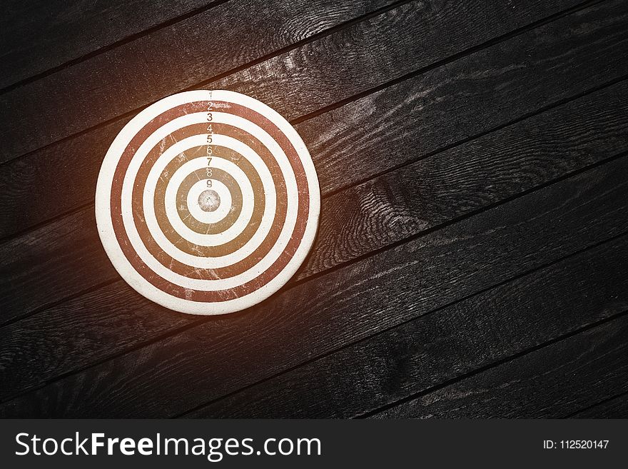 Dart board on dark wooden table. Business concept.