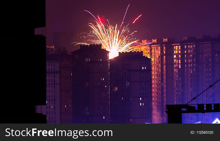 Fireworks Display Near High Rise Buildings During Nighttime