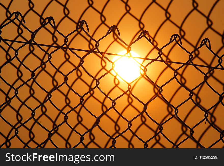 Sun over the Cyclone Fence