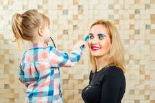 Cute Little Girl Are Doing Funny Make Up To Her Mother. Royalty Free Stock Image