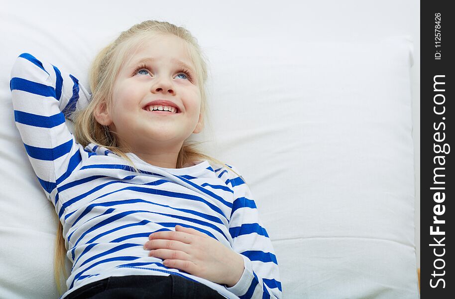 Little girl portrait . Kid lying and relax.