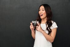 Excited Woman Photographer Holding Camera Stock Images