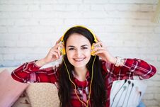 Portrait Of Beautiful Woman In Morning Listening Music Sitting On Bed At Home Royalty Free Stock Photos