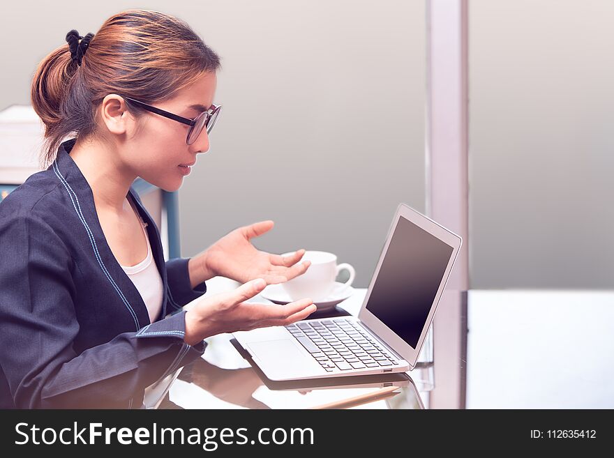 Asian office woman surprise or amazing mood , laptop in office, business woman working in office with surprise mood, woman looking screen of laptop and hand up