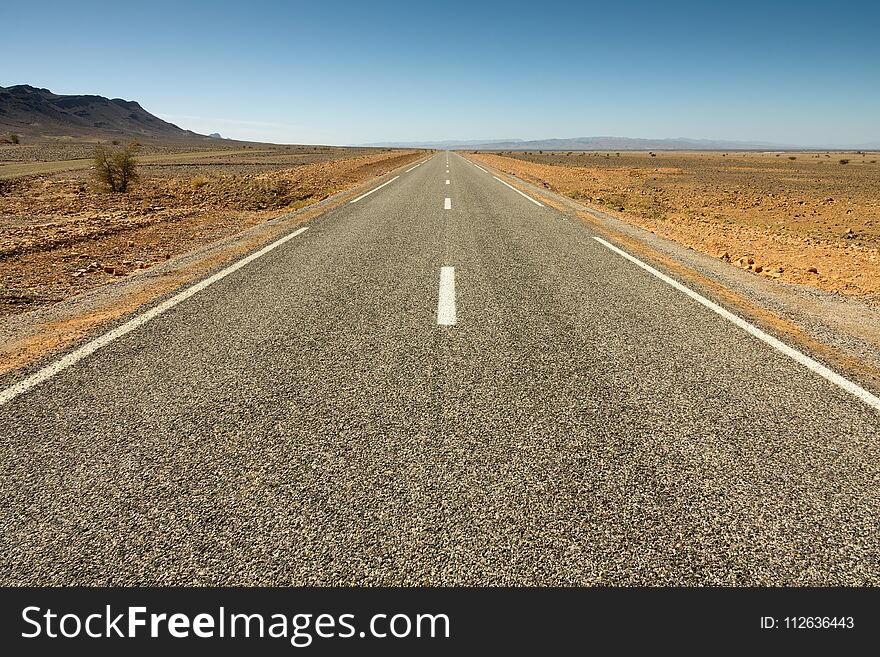 Asphalt road in a rocky desert