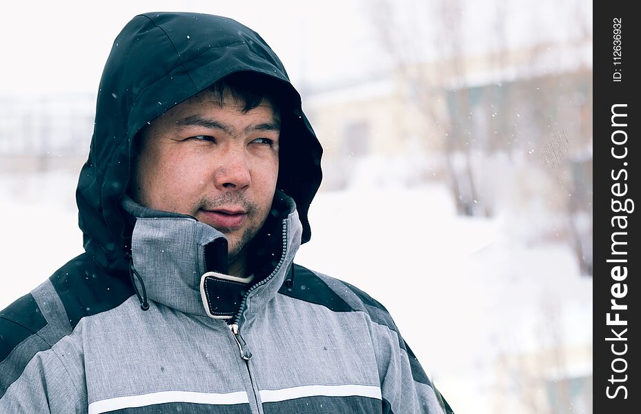 Portrait of a young man with a hood on his head