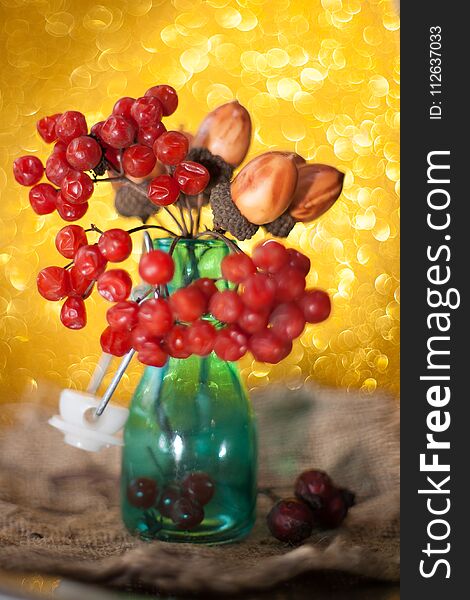 Ripe bunch of red viburnum on a beautiful bokeh background rustic style still life on a table Viburnum kalina red berries close up. Ripe bunch of red viburnum on a beautiful bokeh background rustic style still life on a table Viburnum kalina red berries close up