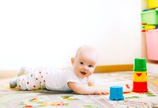Baby Playing With Colorful Toys At Home. Stock Photos