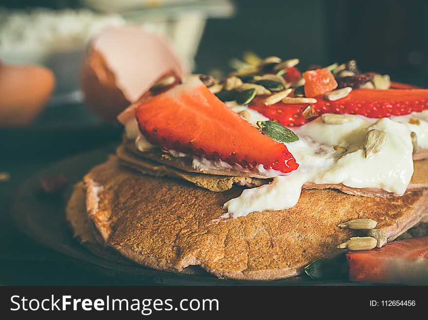 Strawberry pancakes. Close-up of a pancake with strawberries and cream. Strawberry pancakes. Close-up of a pancake with strawberries and cream