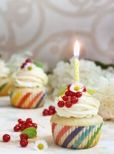 Gentle Cupcake With Cream And Berries Nd A Candle A Light Background Royalty Free Stock Photo