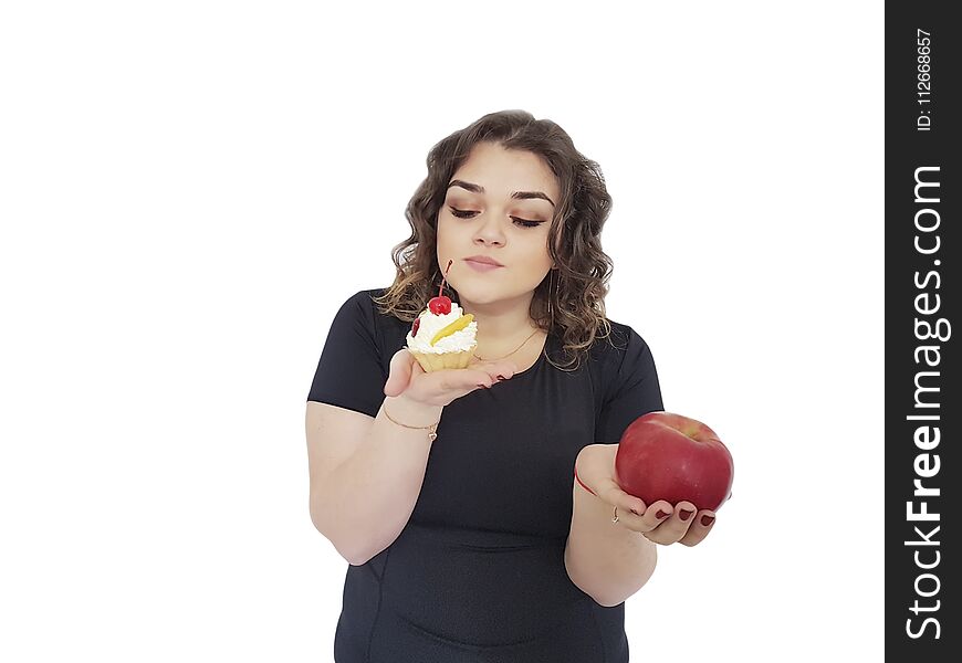 Full girl with a cake and an apple isolated dilemma