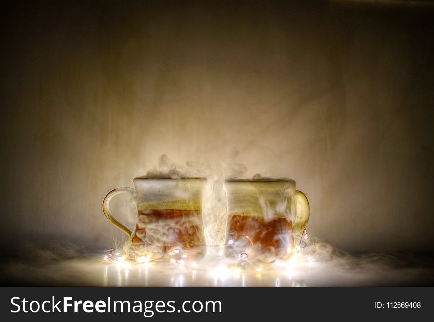 Two Red and Gold Mugs and Yellow String Lights