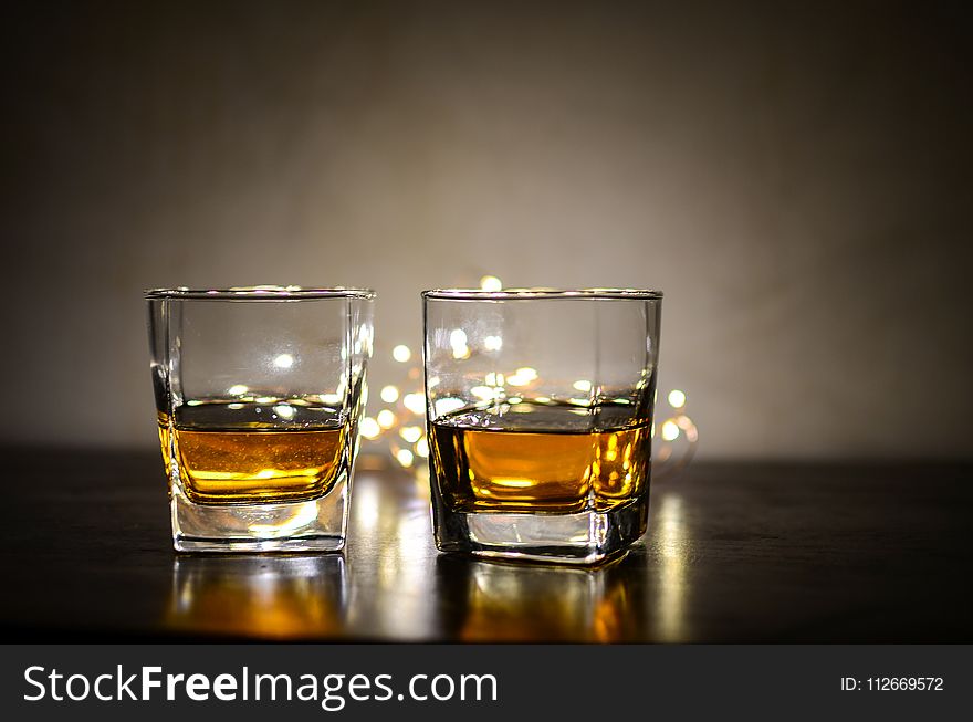 Two Clear Shot Glasses With Brandy