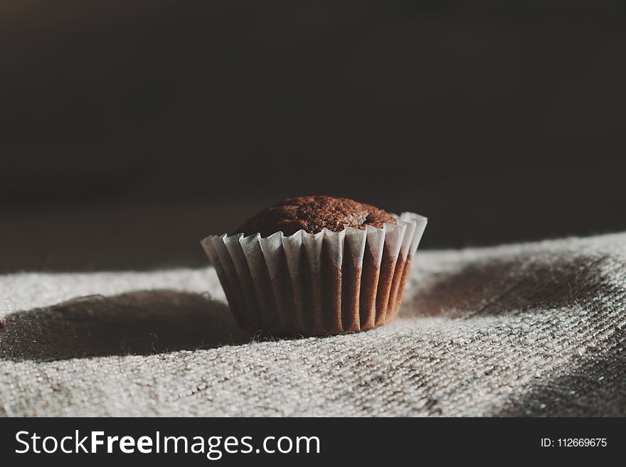 Still Life Photography of Muffin on White Textile
