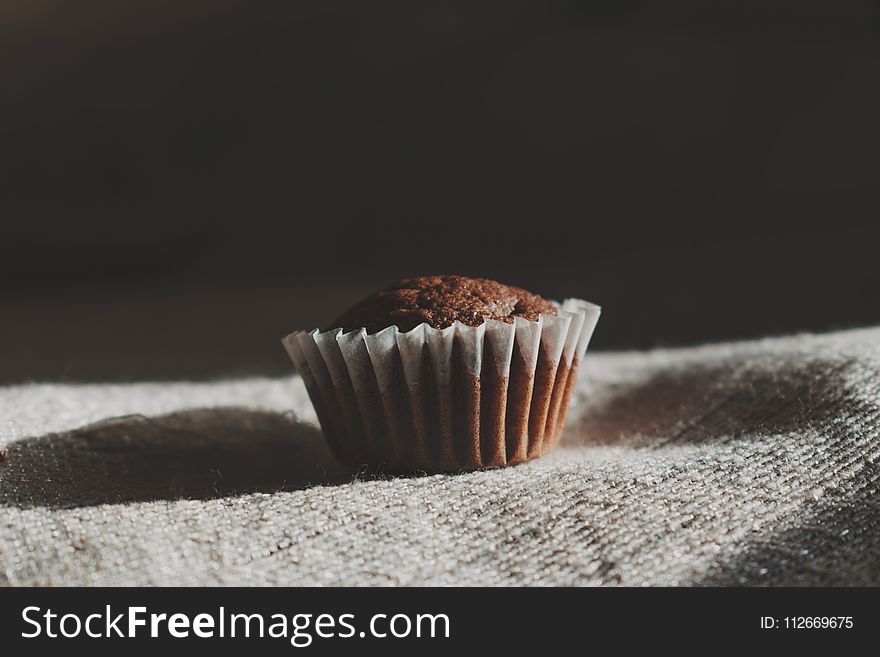 Still Life Photography Of Muffin On White Textile