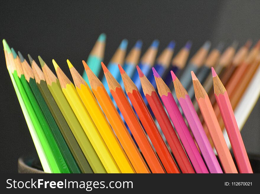 Multi-color pencils in black cup. Multi-color pencils in black cup