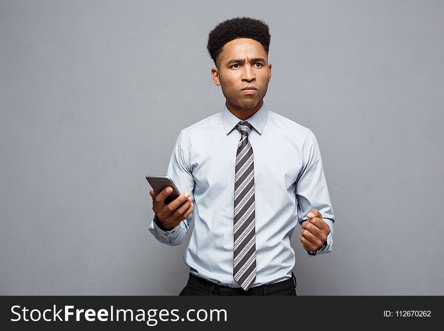 Business Concept - Stressful African American Businessman Shouting And Screaming On Mobile Phone.