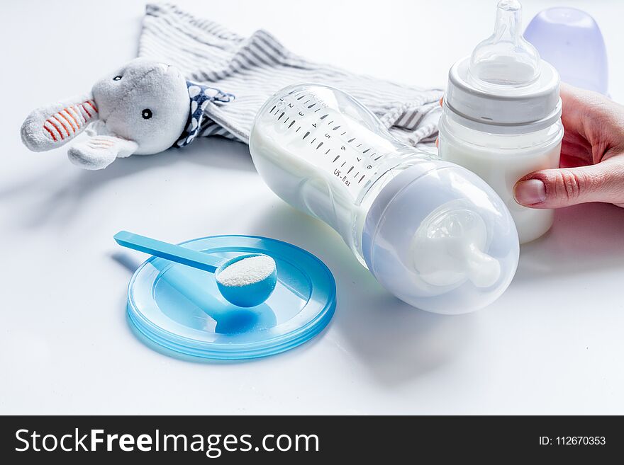 Preparation of mixture baby feeding on white background