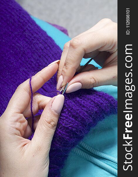 A Woman Knits Knitting, Lying In Bed. A Product Made Of String Of Purple.