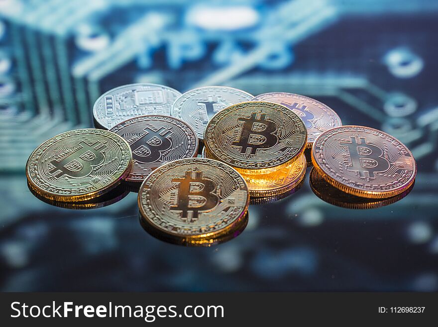 Mining Bitcoin Gold, Silver And Copper Coins And Defocused Print