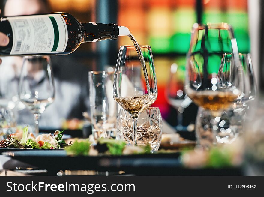 Sommelier pouring wine into glass at wine tasting