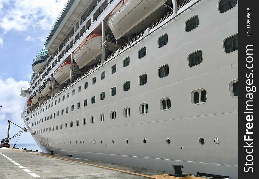 Large cruise ship without name docked in empty port. Large cruise ship without name docked in empty port