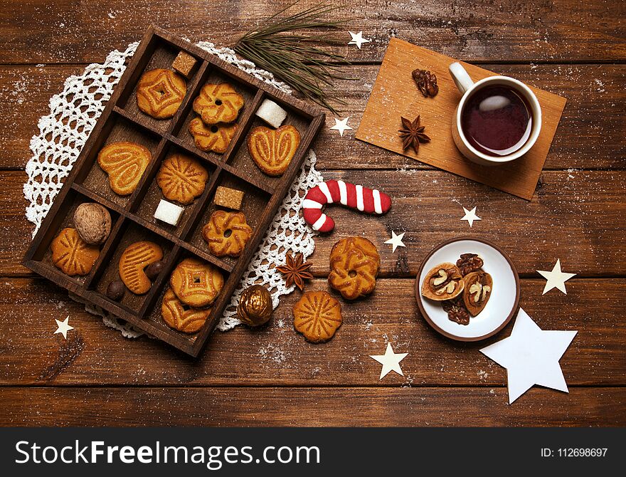 New Year`s day breakfast tea with nuts and sugar cane on wooden background