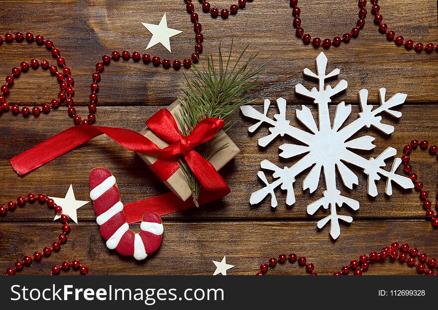 Sugar cane and snow flake on wooden background with presents.