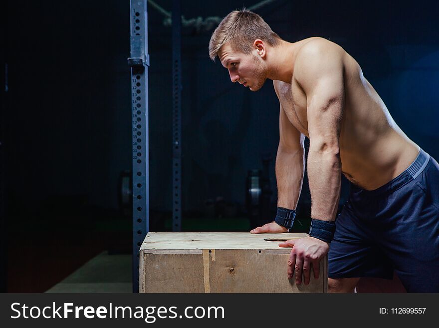 Portrait Of Fatigued Fitness Guy. Near The Wooden Cube. Cross Fit Style.