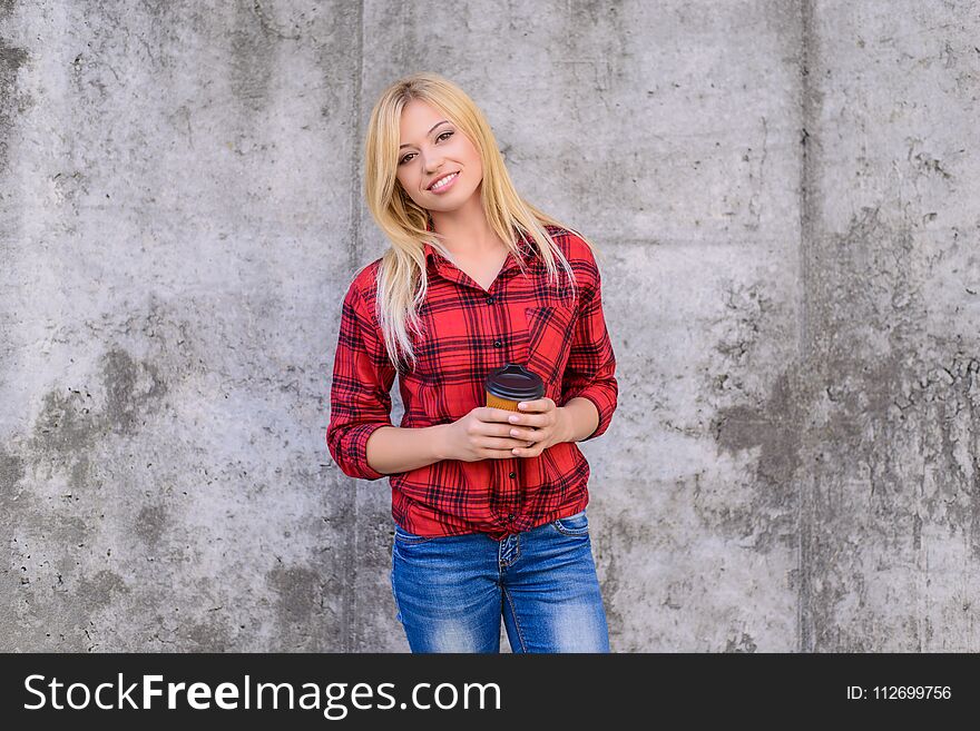 It`s coffee time! Coffee time concept. Woman with beaming smile drinking coffee. Close up portrait, grey background