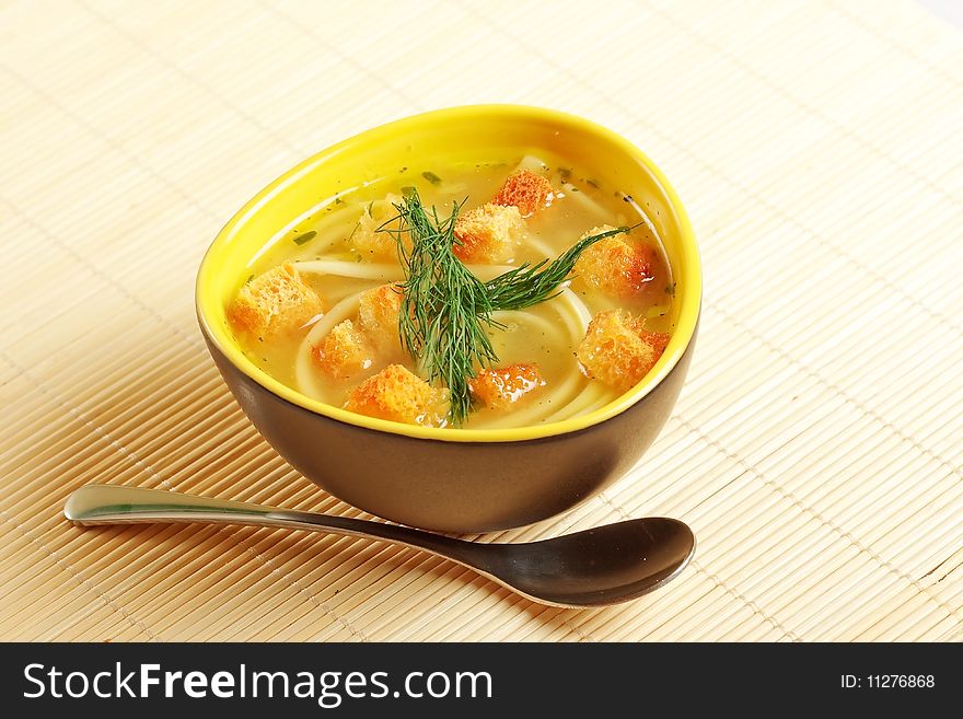Close up image of a bowl of chicken noodle soup