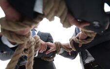 Closeup.business Team Holding Rope Forming A Circle Stock Photo