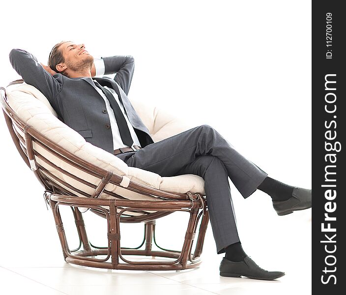 Happy businessman relaxing in big comfortable armchair