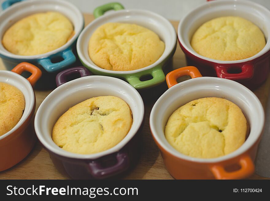 Cottage cheese casserole in colored ceramic forms in the form of pans. kid`s food
