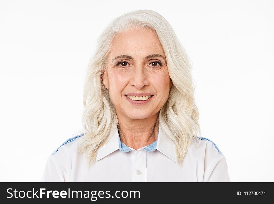 Image of mature old cheerful woman standing isolated over white background looking camera.