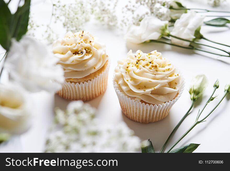 Vanilla cupcakes and white flowers. Vanilla cupcakes and white flowers