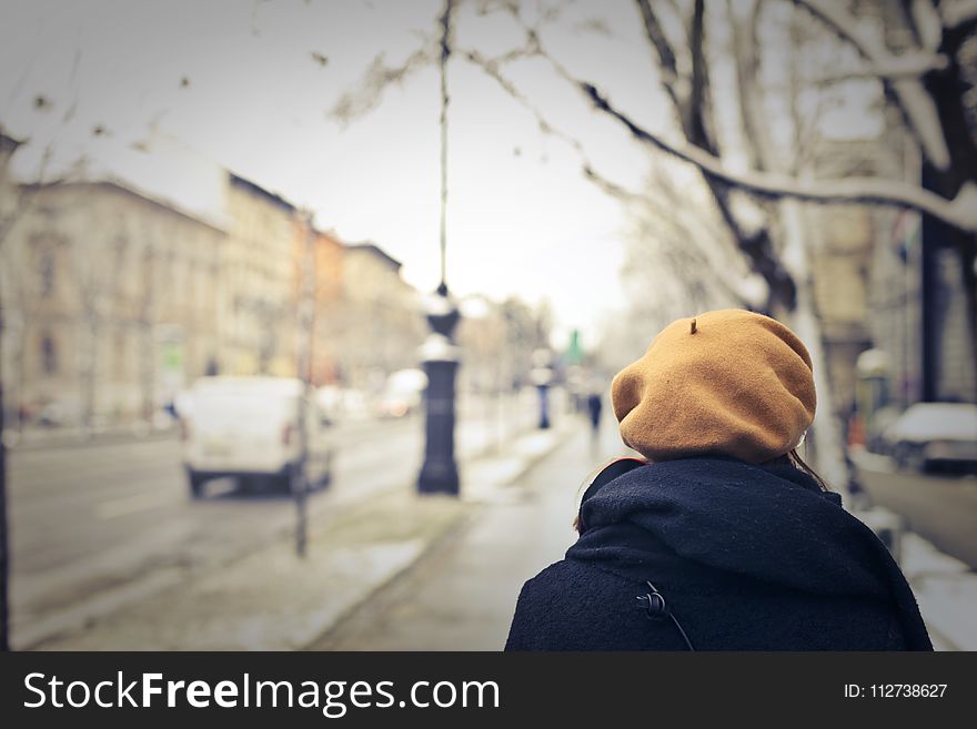 Person With Brown Hat Walking on Street