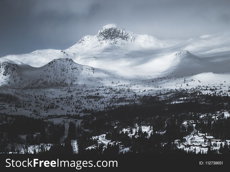 Mountain Coated With Snow Under Gray Sky
