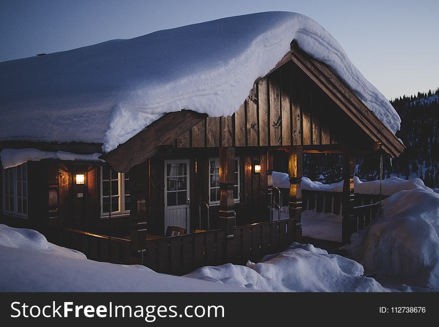 Brown Wooden House during Snow