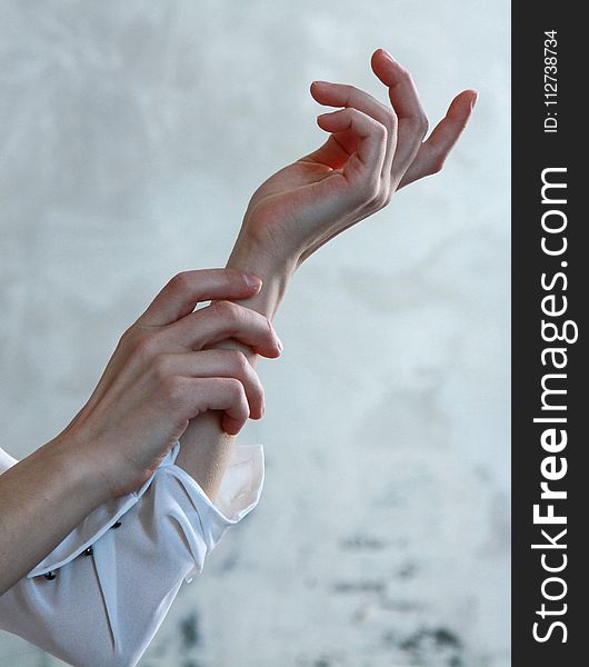 Person in White Long-sleeve Shirt With Both Hands Photo