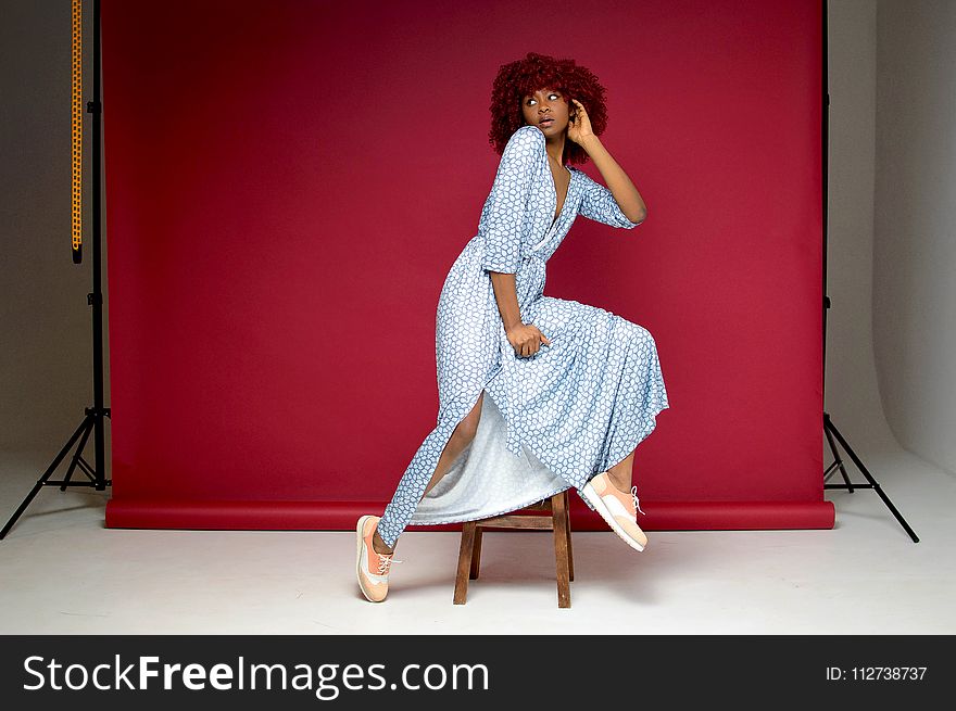 Woman Wearing White and Blue Dress Posing for Picture