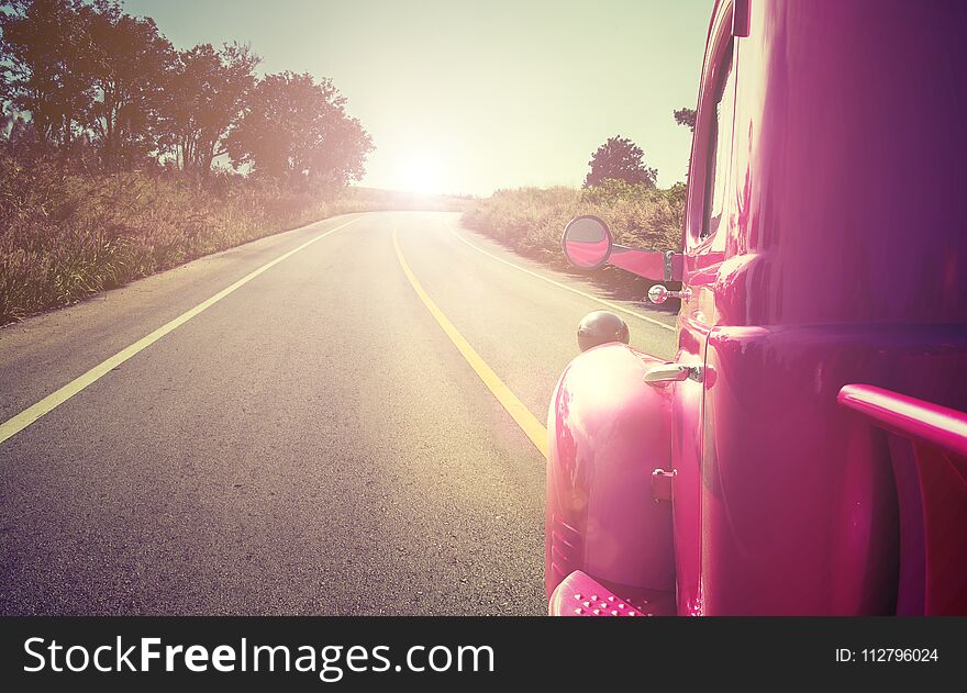 Pink retro car on the road travel concept