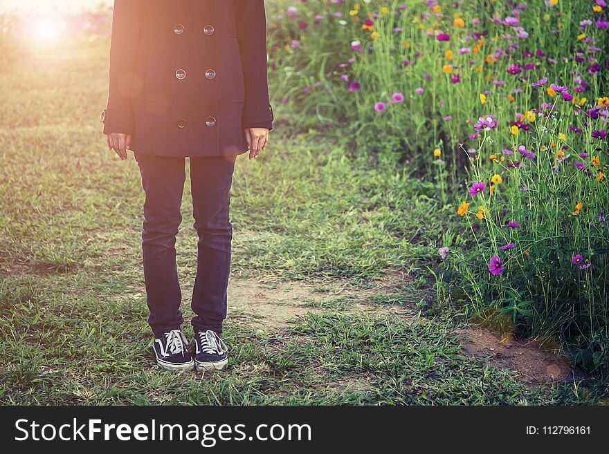 Beautiful Women Wearing Black Coat, Standing In A Field Of Flowers.