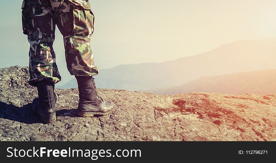 Soldier on the top of a mountain and background