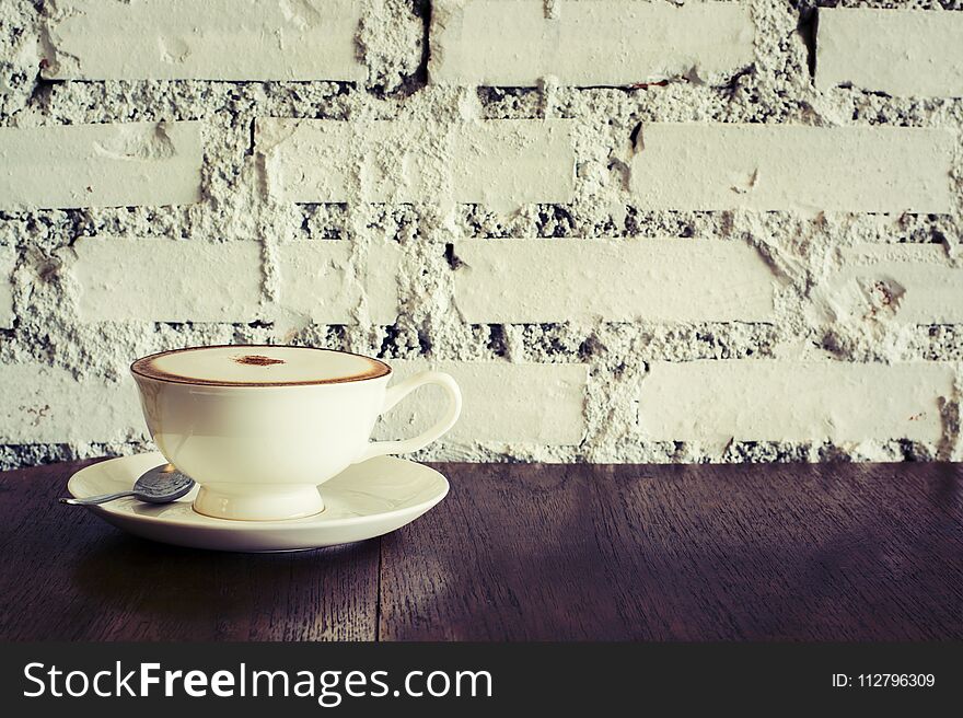 Coffee cup Espresso on wood table brick wall background and shop