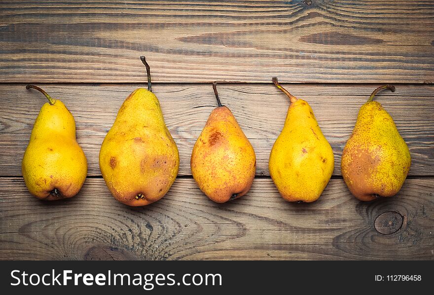 A Group Of Ripe Autumn Pears On A Wooden Table. Top View