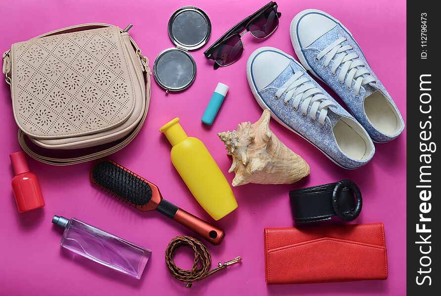 What&#x27;s in the women&#x27;s bag? Going on a trip. Girly fashionable spring and summer accessories.