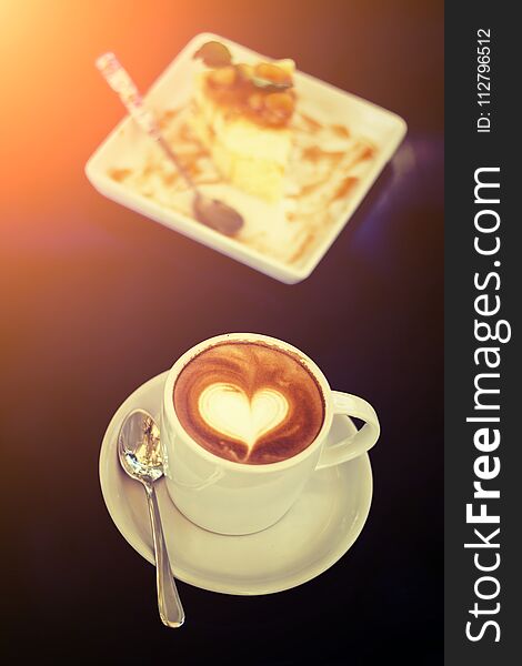 White cups of Cappuccino coffee with heart shaped milk foam and shop